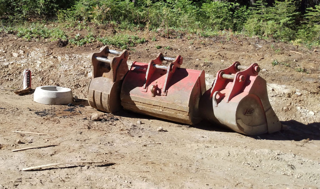 Backhoe Buckets On Side Of Road